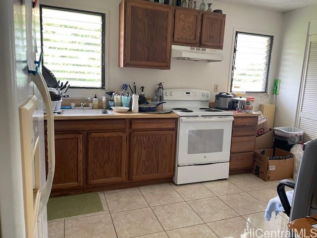 47-166 Wailehua Road Kaneohe, HI 96744 - Photo 15 of 17 a kitchen with a stove sink and cabinets