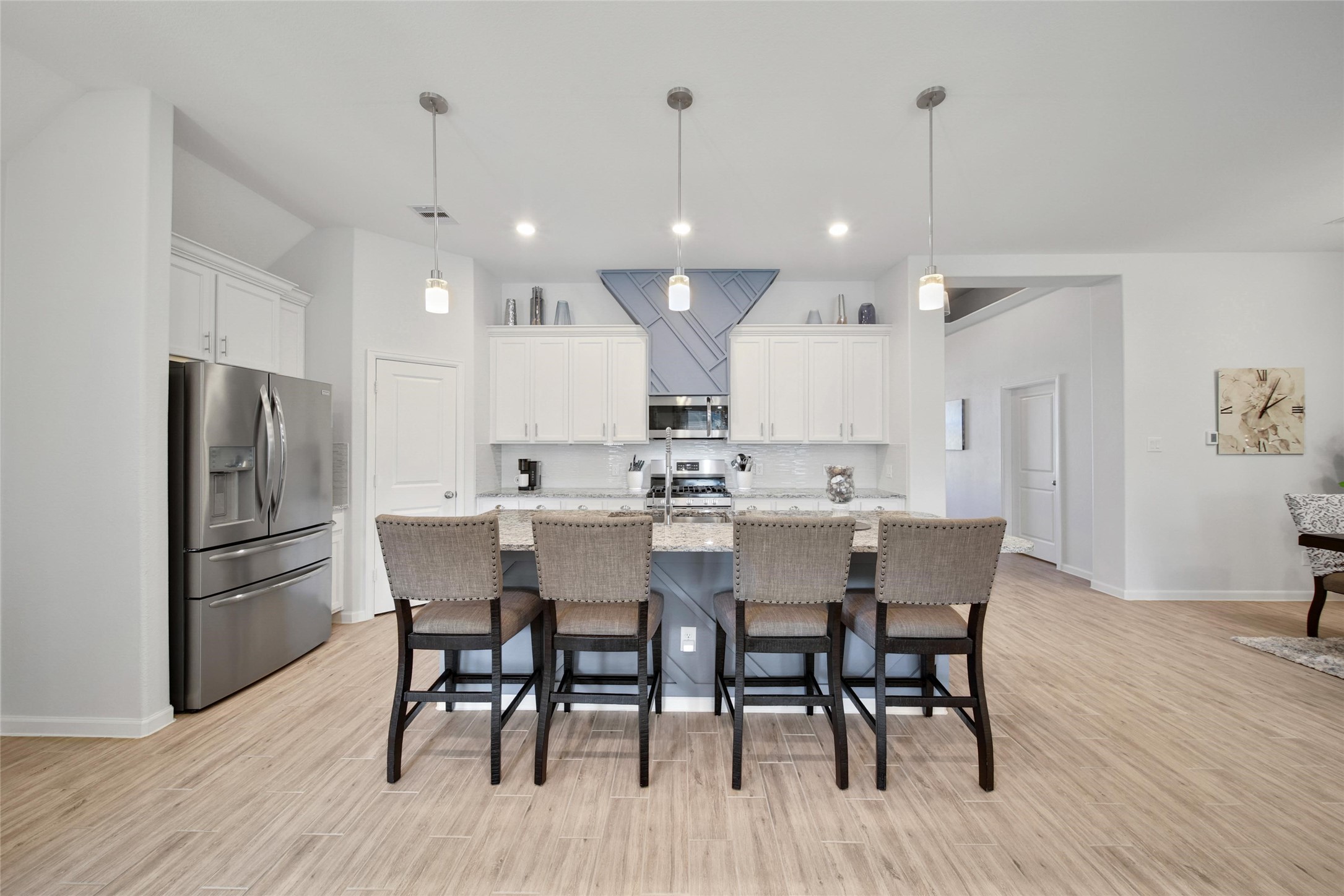 3422 Warwick River Trail Houston, TX 77365 - Photo 12 of 46 a dining room with stainless steel appliances kitchen island granite countertop a dining table chairs with wooden floor and kitchen view