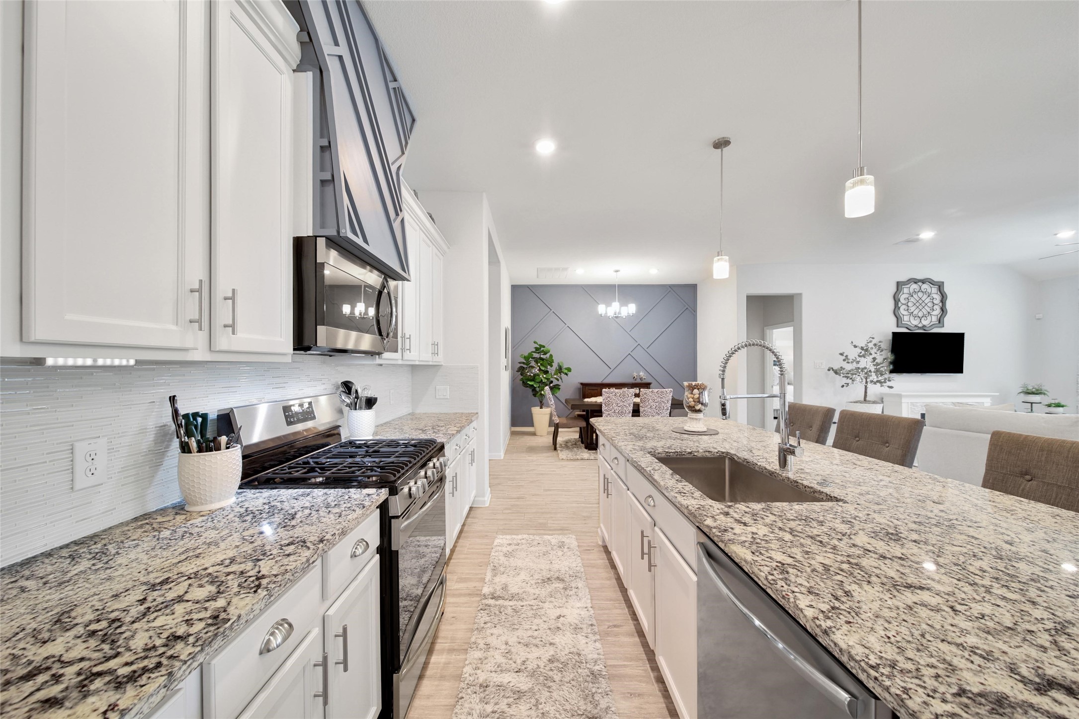 3422 Warwick River Trail Houston, TX 77365 - Photo 15 of 46 a large kitchen with granite countertop a sink a counter top space and cabinets