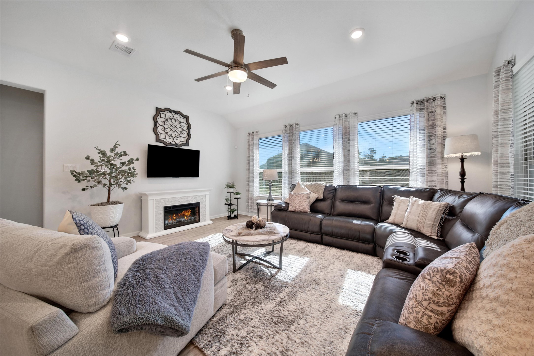 3422 Warwick River Trail Houston, TX 77365 - Photo 23 of 46 a living room with furniture a fireplace and a flat screen tv