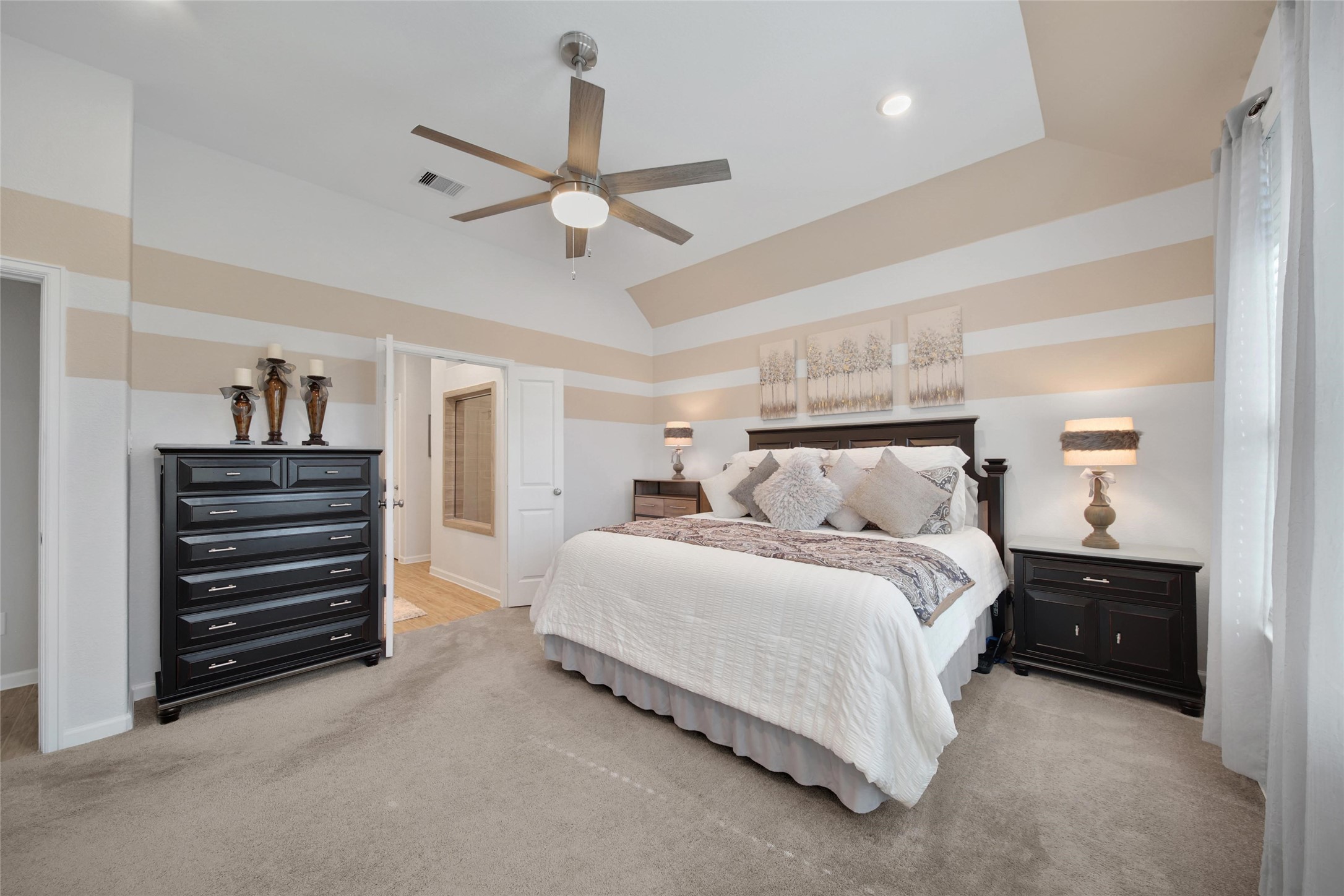 3422 Warwick River Trail Houston, TX 77365 - Photo 24 of 46 a spacious bedroom with a bed and a chandelier