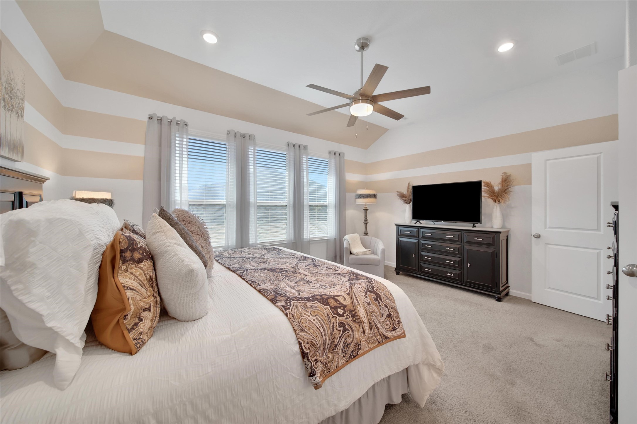 3422 Warwick River Trail Houston, TX 77365 - Photo 26 of 46 a spacious bedroom with a bed and a flat screen tv