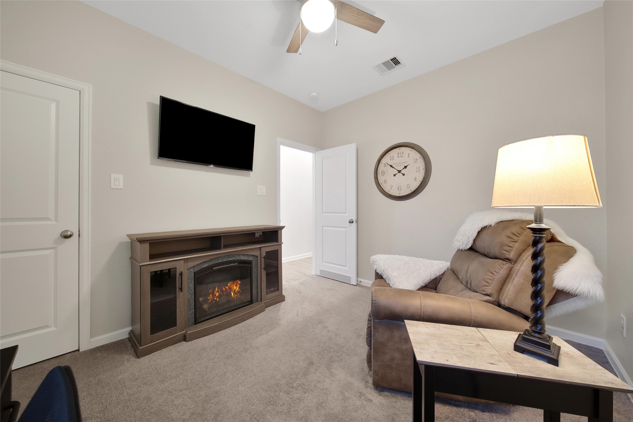3422 Warwick River Trail Houston, TX 77365 - Photo 31 of 46 a living room with furniture a fireplace and a flat screen tv