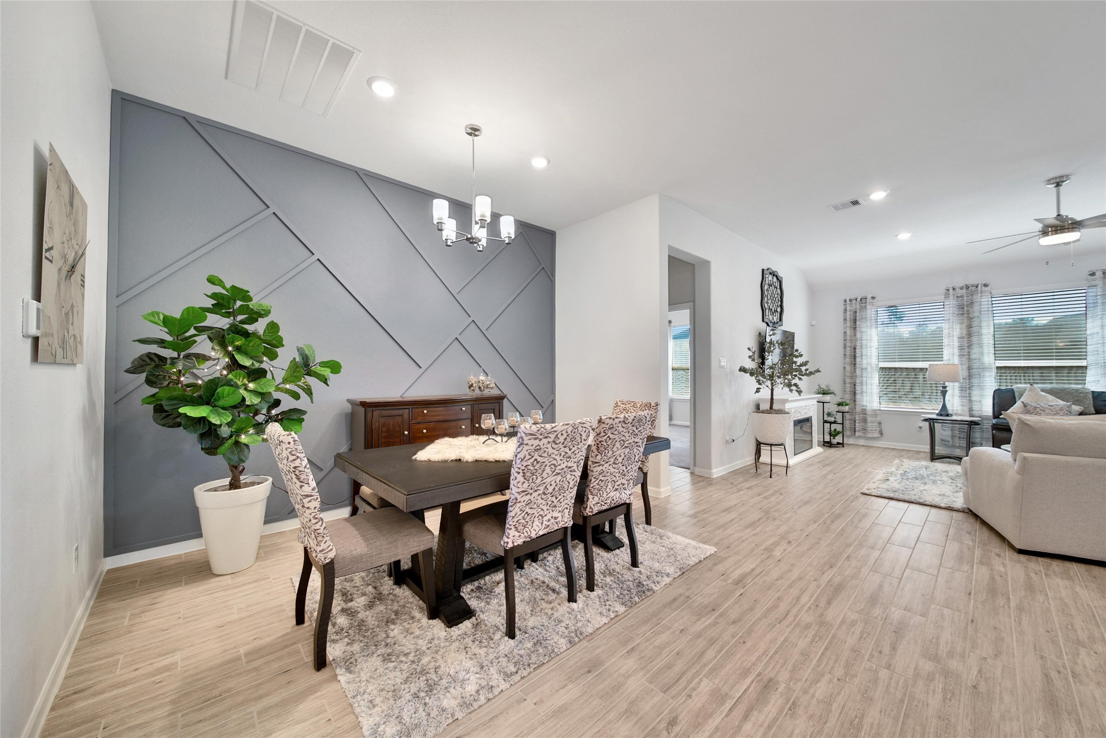 3422 Warwick River Trail Houston, TX 77365 - Photo 6 of 46 a dining room with furniture potted plants and wooden floor