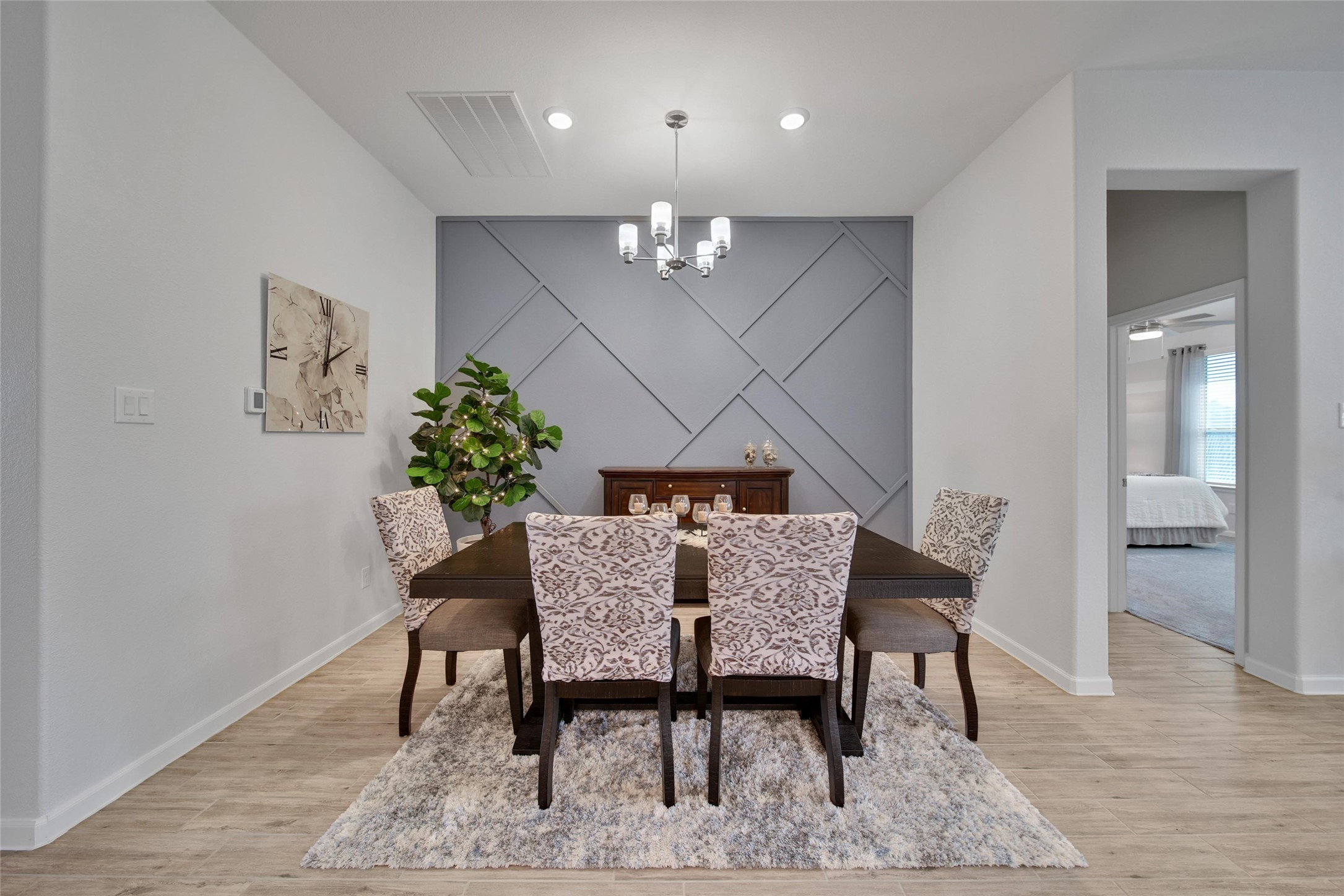 3422 Warwick River Trail Houston, TX 77365 - Photo 8 of 46 a dining room with furniture a chandelier and wooden floor