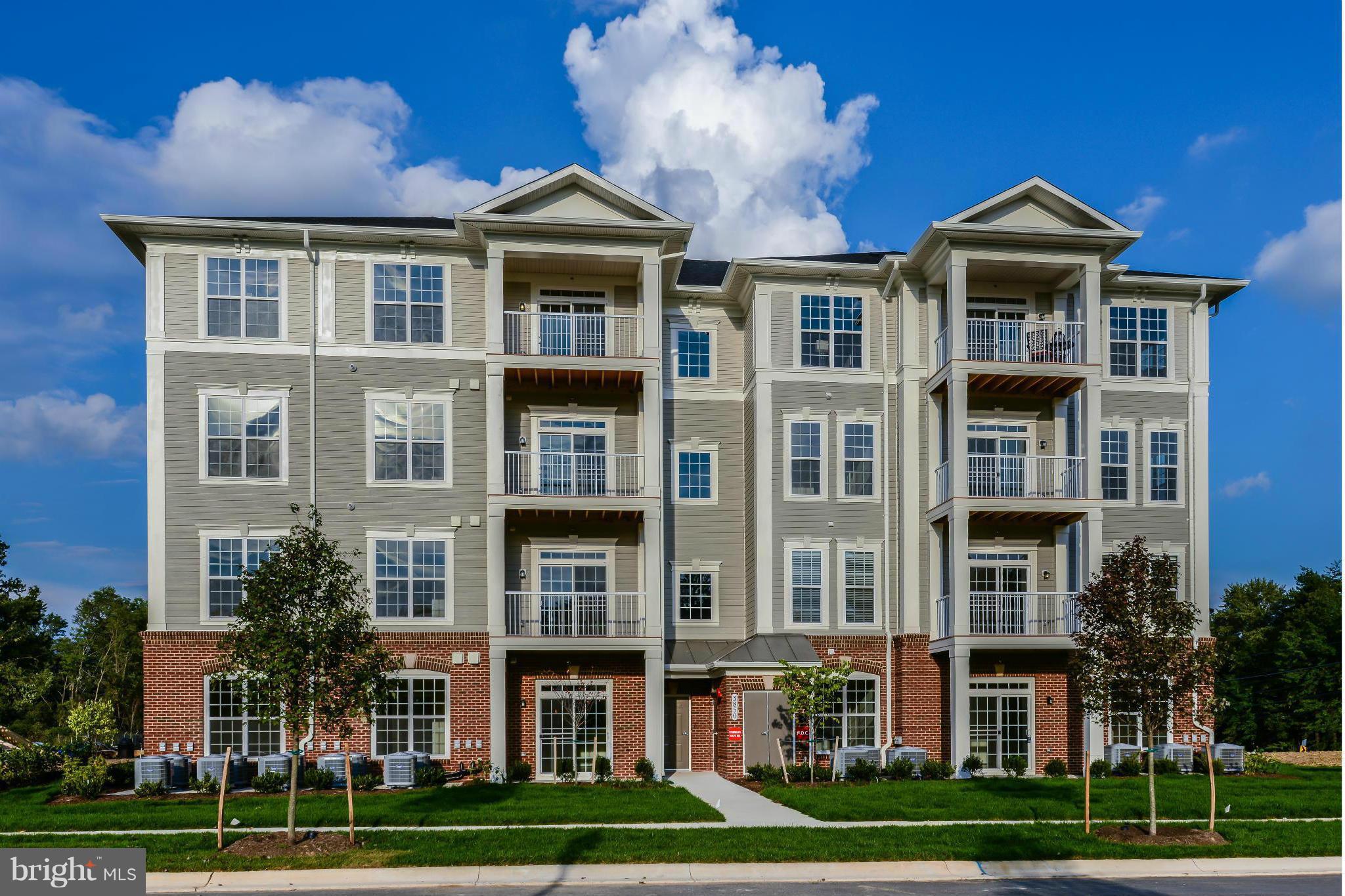 a front view of a residential apartment building with a yard