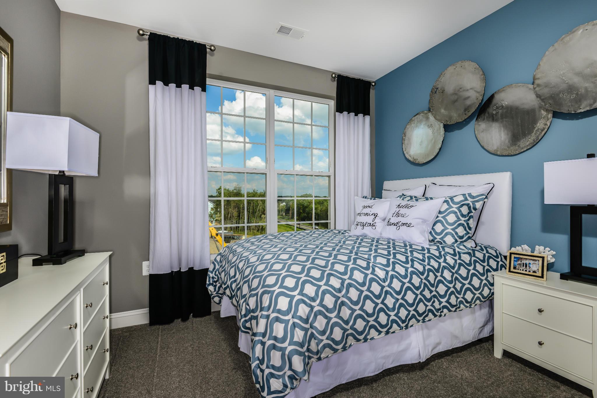 3750 Clara Downey Avenue, Unit 35 Silver Spring, MD 20906 - Photo 13 of 14 a bedroom with a large bed and a window