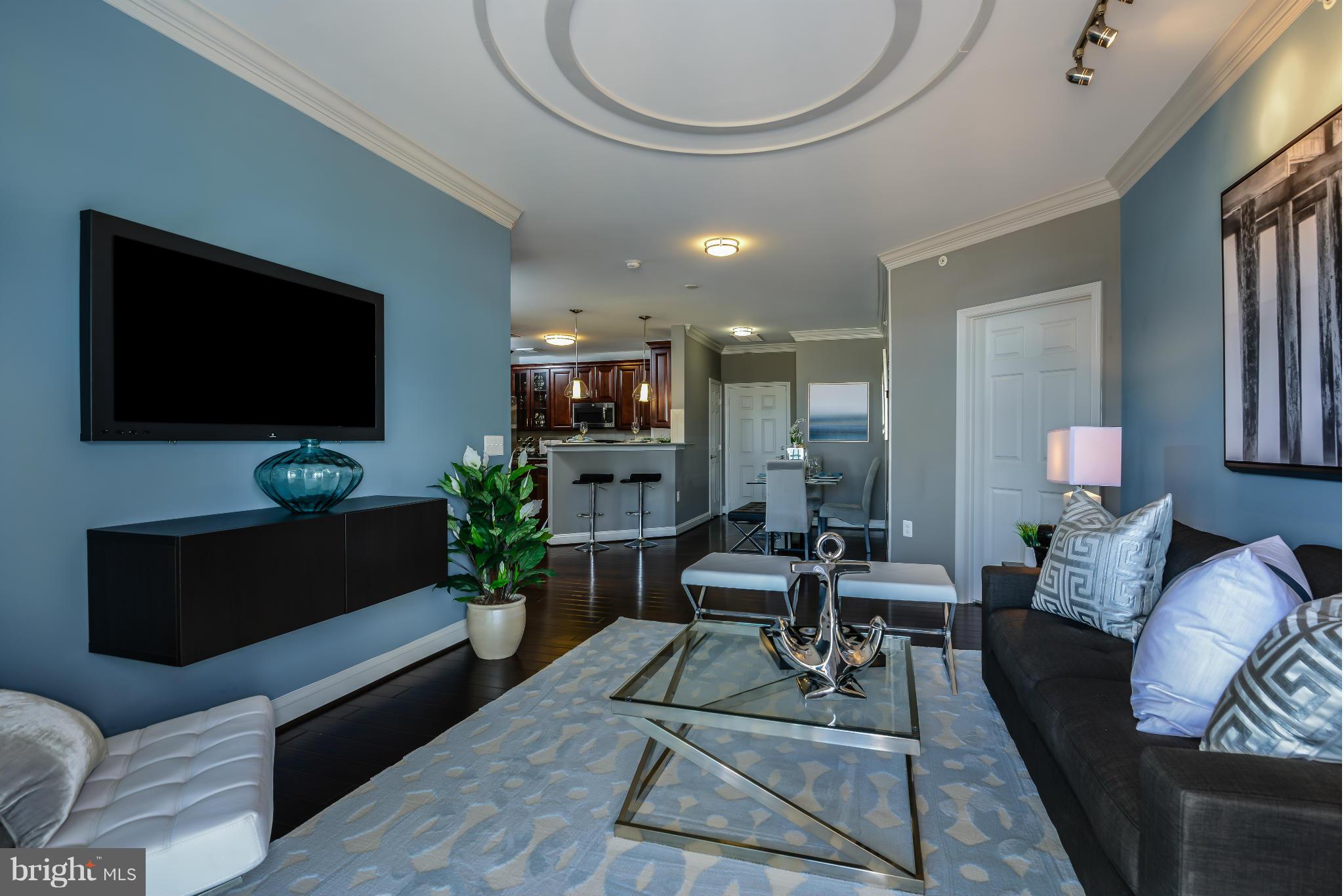 3750 Clara Downey Avenue, Unit 35 Silver Spring, MD 20906 - Photo 7 of 14 a living room with furniture a flat screen tv and a large window