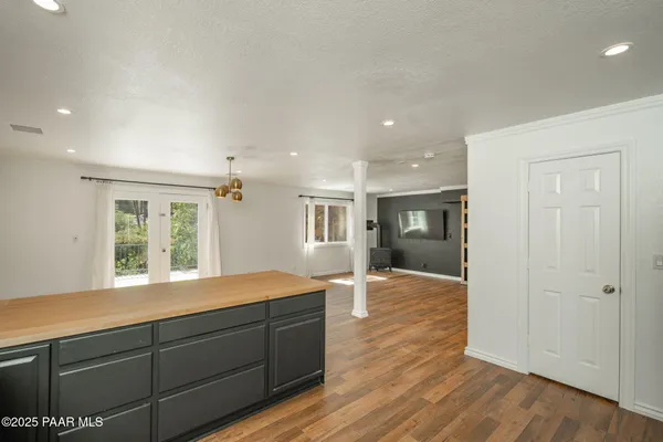 a view of empty room with wooden floor