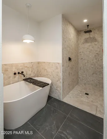 a large kitchen with granite countertop a large counter top space a sink stainless steel appliances and cabinets