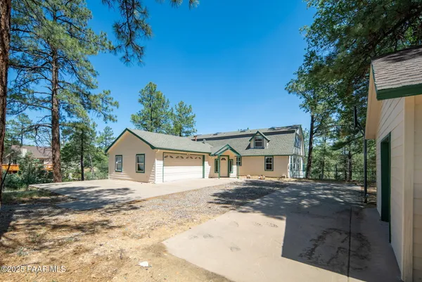 a view of a big room with wooden floor mirror and windows
