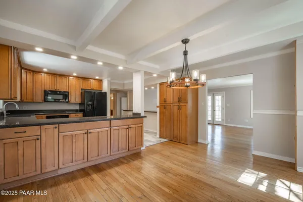 a view of a room with wooden floor and a bathroom