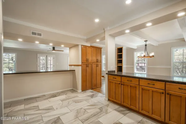 a view of a livingroom with a window and wooden floor