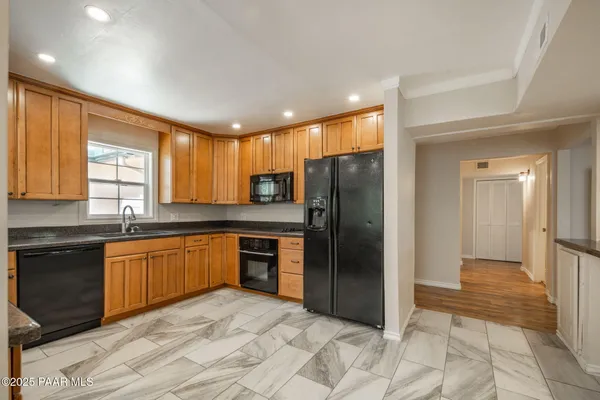 a view of an empty room with closet and a window