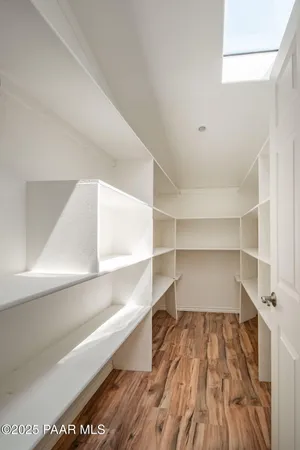 an outdoor view of a house with cars parked