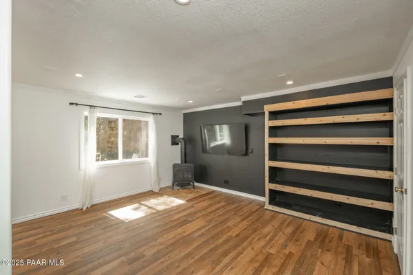 a living room with wooden floors and a dresser