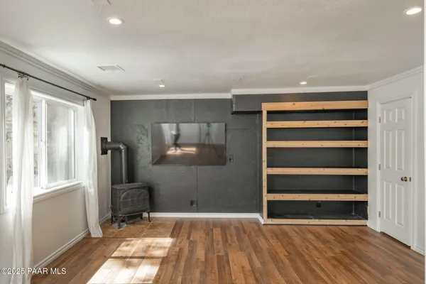 a large kitchen with stainless steel appliances granite countertop a lot of counter space and wooden floors