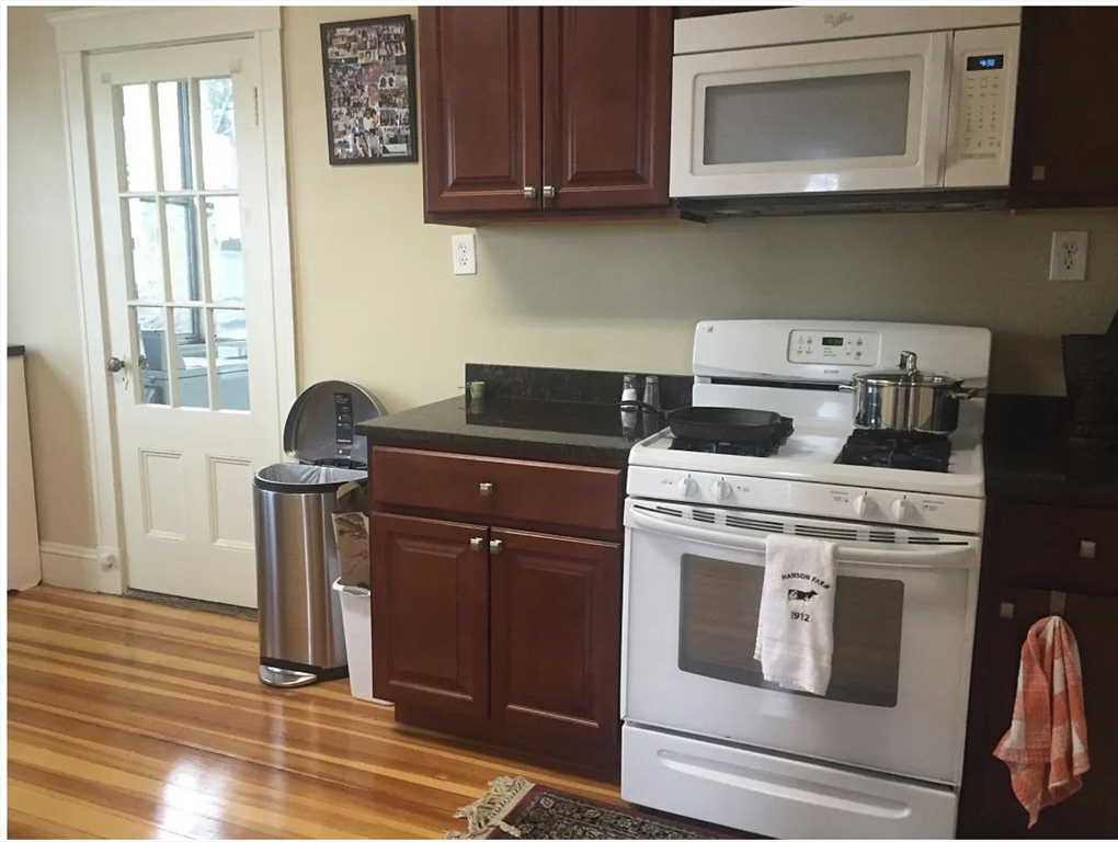 30 Lawrence Street, Unit 2 Everett, MA 02149 - Photo 6 of 13 a stove top oven sitting inside of a kitchen
