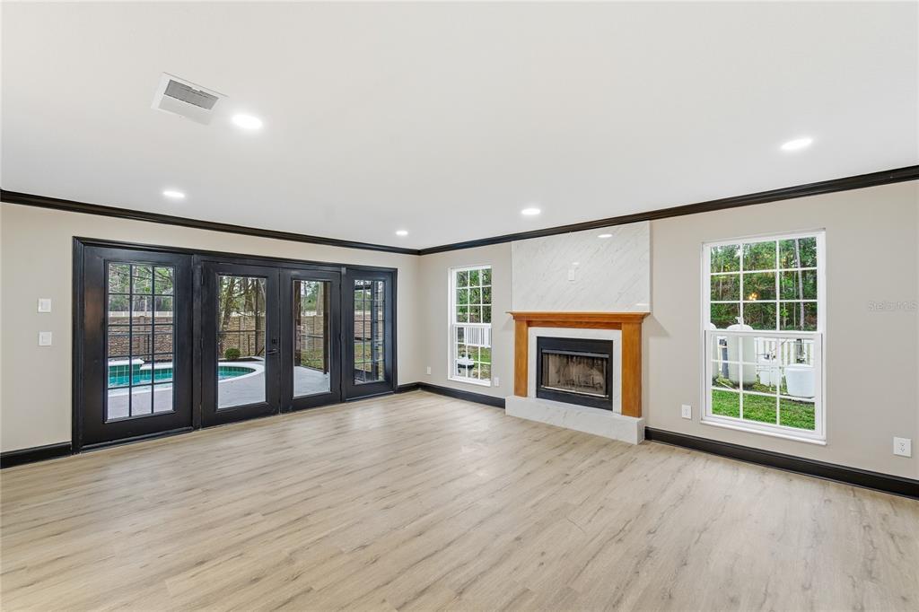 14728 Henson Road Orlando, FL 32832 - Photo 62 of 79 a view of an empty room with wooden floor and a fireplace