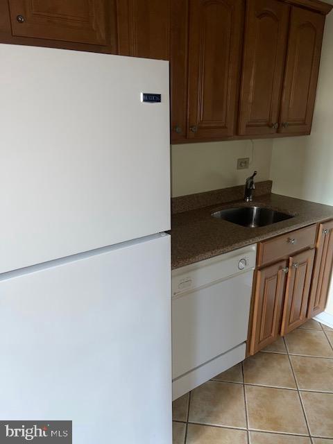 3601 Wisconsin Avenue Northwest, Unit 309 Washington, DC 20016 - Photo 6 of 14 a kitchen with a sink and a refrigerator