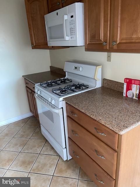 3601 Wisconsin Avenue Northwest, Unit 309 Washington, DC 20016 - Photo 7 of 14 a kitchen with granite countertop a stove a sink and dishwasher