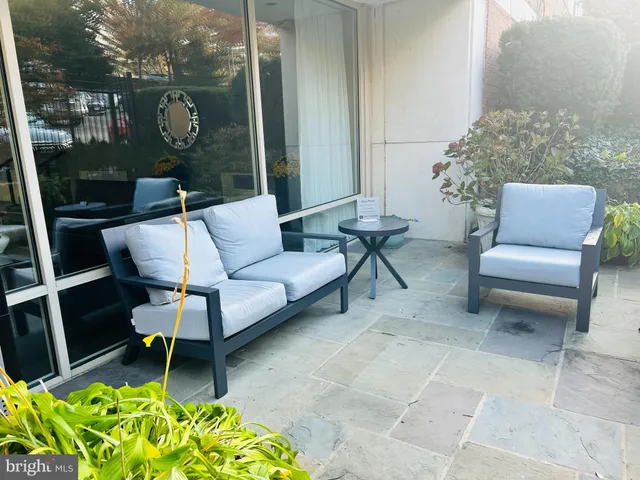 a balcony with furniture and a potted plant