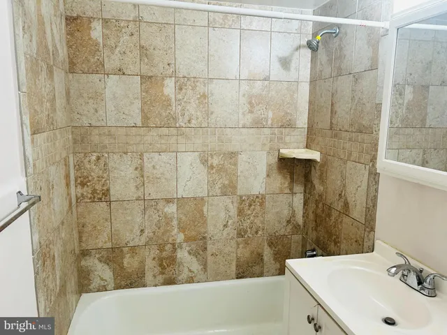 a bathroom with a sink and shower