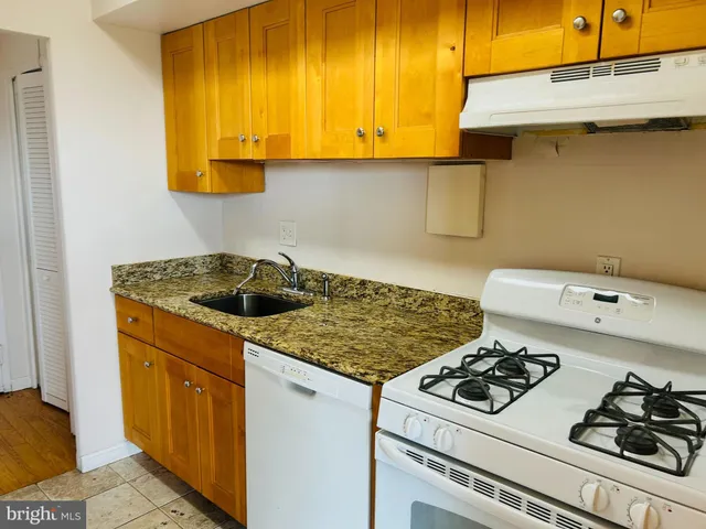 a kitchen with a stove and a sink