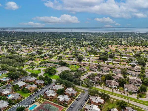 an aerial view of residential building with green space