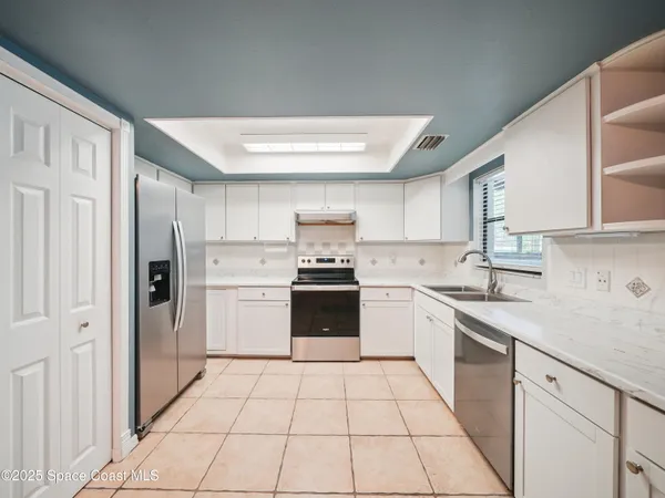 a kitchen with a stove sink and refrigerator