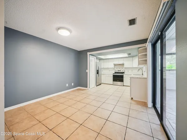 a view of a kitchen with a sink and refrigerator