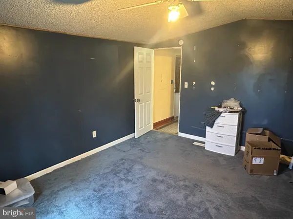 a room with a bed and a television