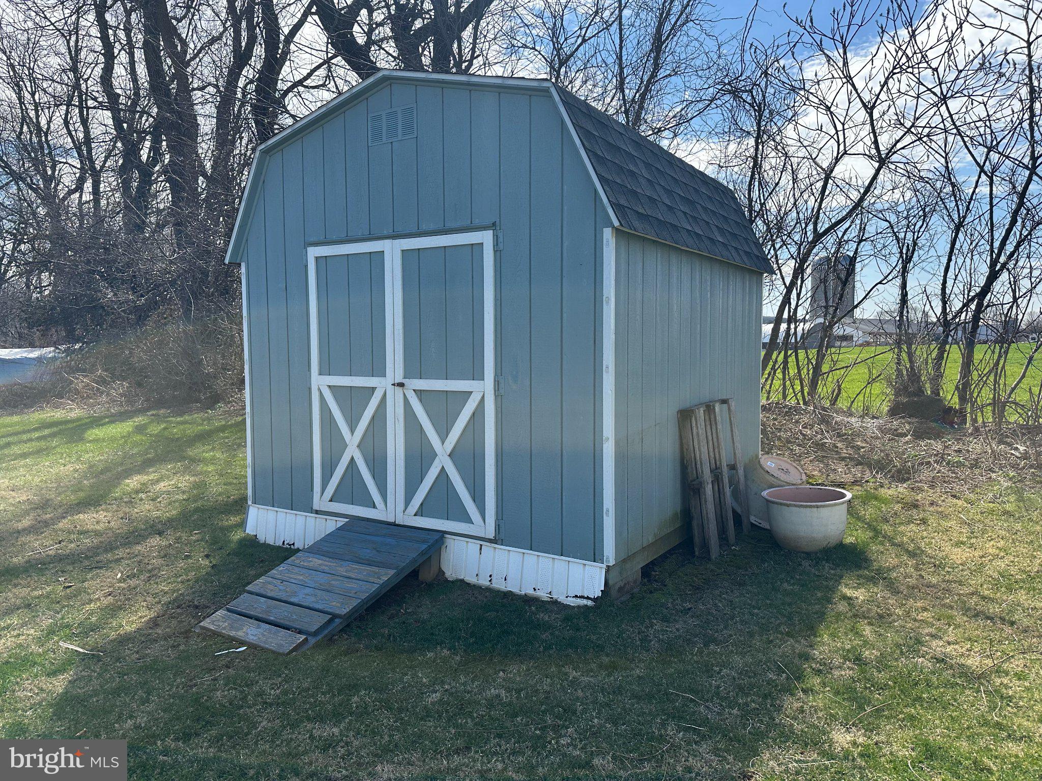 10 Roth Avenue Mertztown, PA 19539 - Photo 18 of 21 a view of a backyard with potted plants and large tree