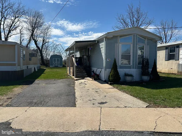 a front view of a house with a yard and garden