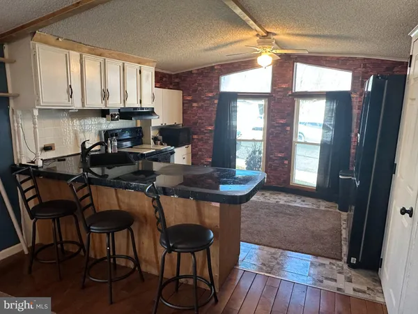 a kitchen with a table chairs and cabinets