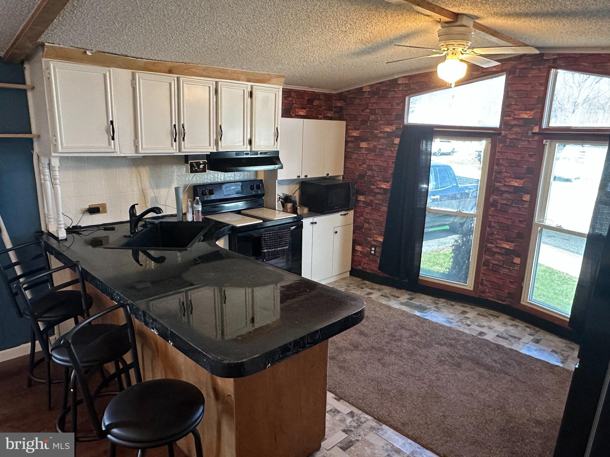 10 Roth Avenue Mertztown, PA 19539 - Photo 8 of 21 a kitchen with a table chairs and cabinets