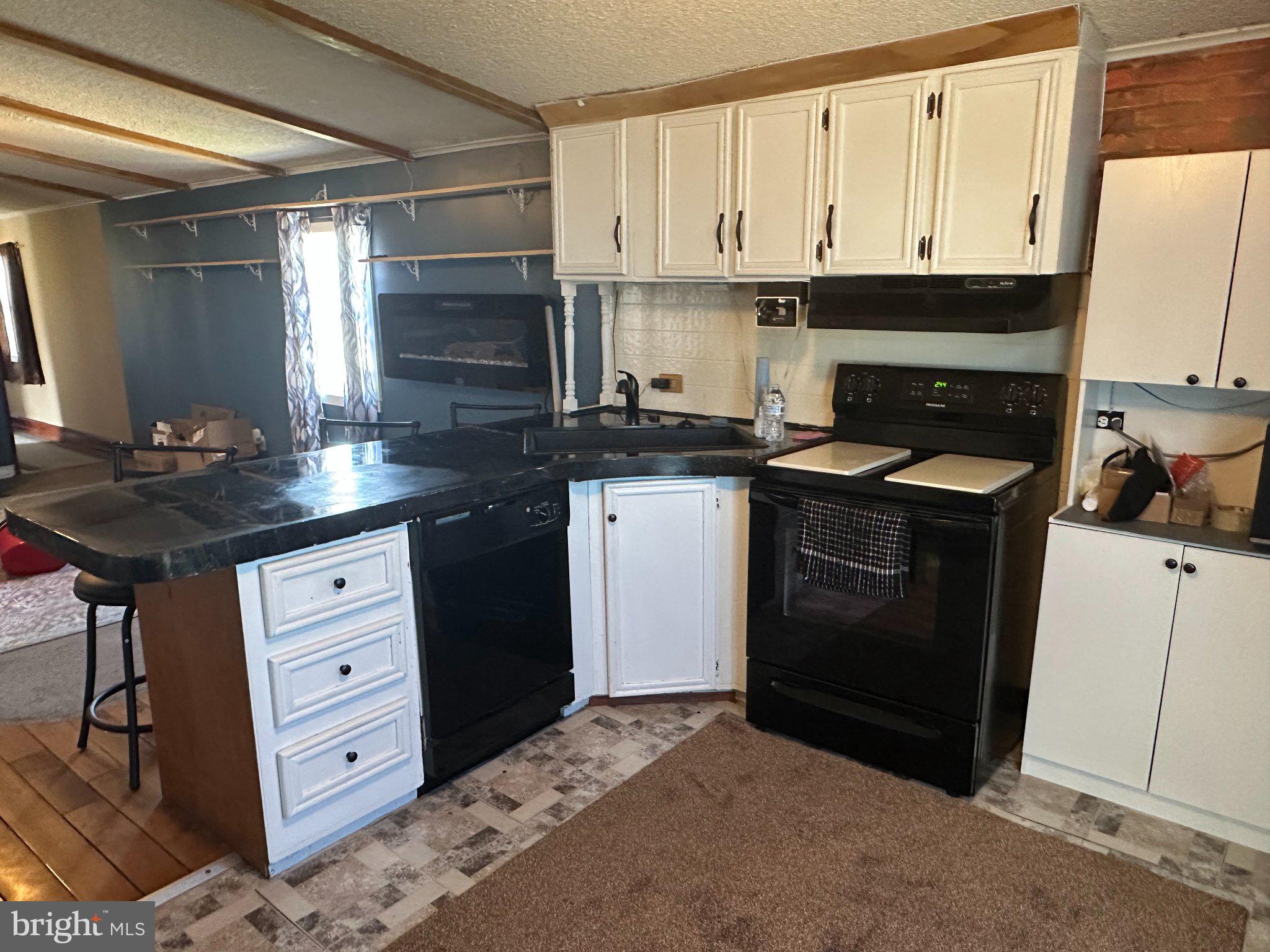 10 Roth Avenue Mertztown, PA 19539 - Photo 9 of 21 a kitchen with stainless steel appliances granite countertop a stove a sink and a microwave