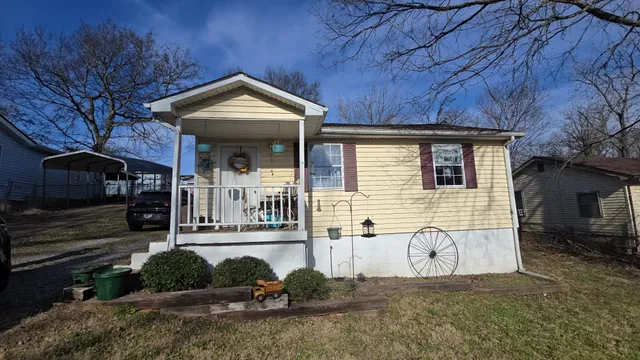 a view of a house with a yard and garage