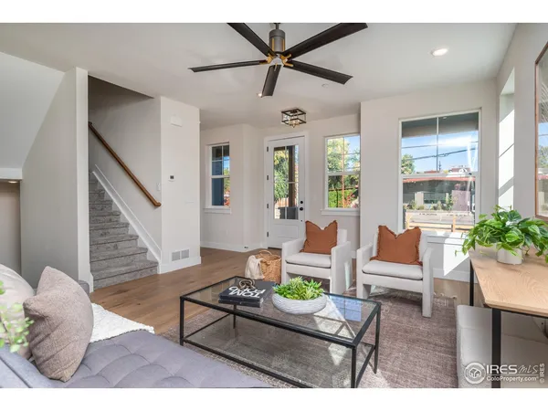 a living room with furniture and wooden floor