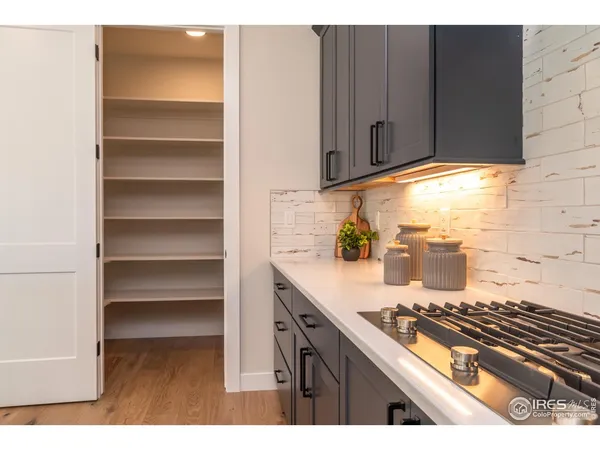 a kitchen with kitchen island a stove and a microwave