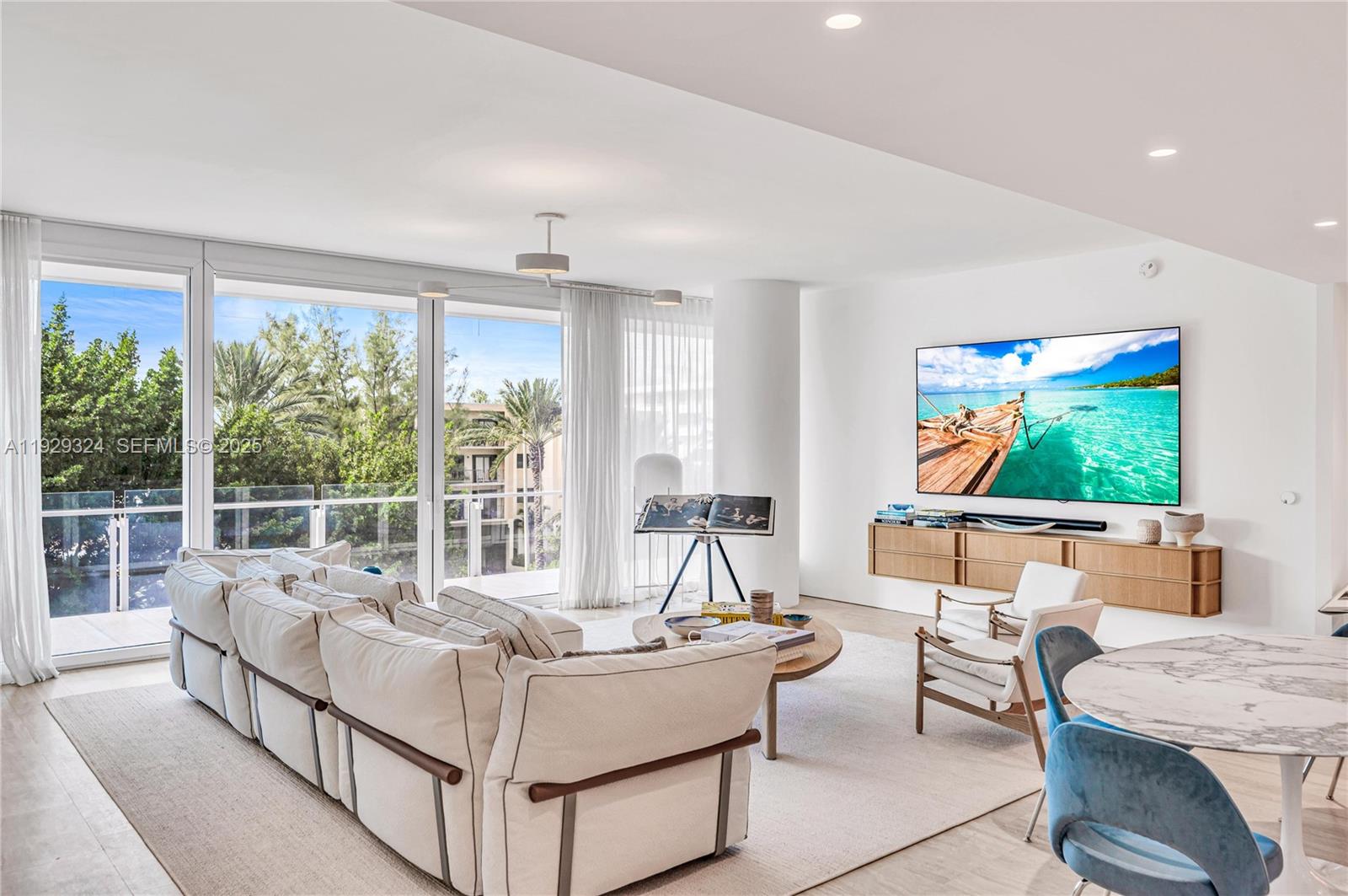 9111 Collins Avenue, Unit N322 Surfside, FL 33154 - Photo 1 of 23 a living room with furniture and a large window