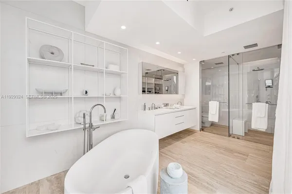 a kitchen with a sink a refrigerator and cabinets