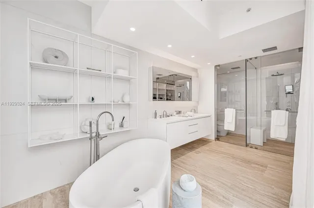 a kitchen with a sink a refrigerator and cabinets