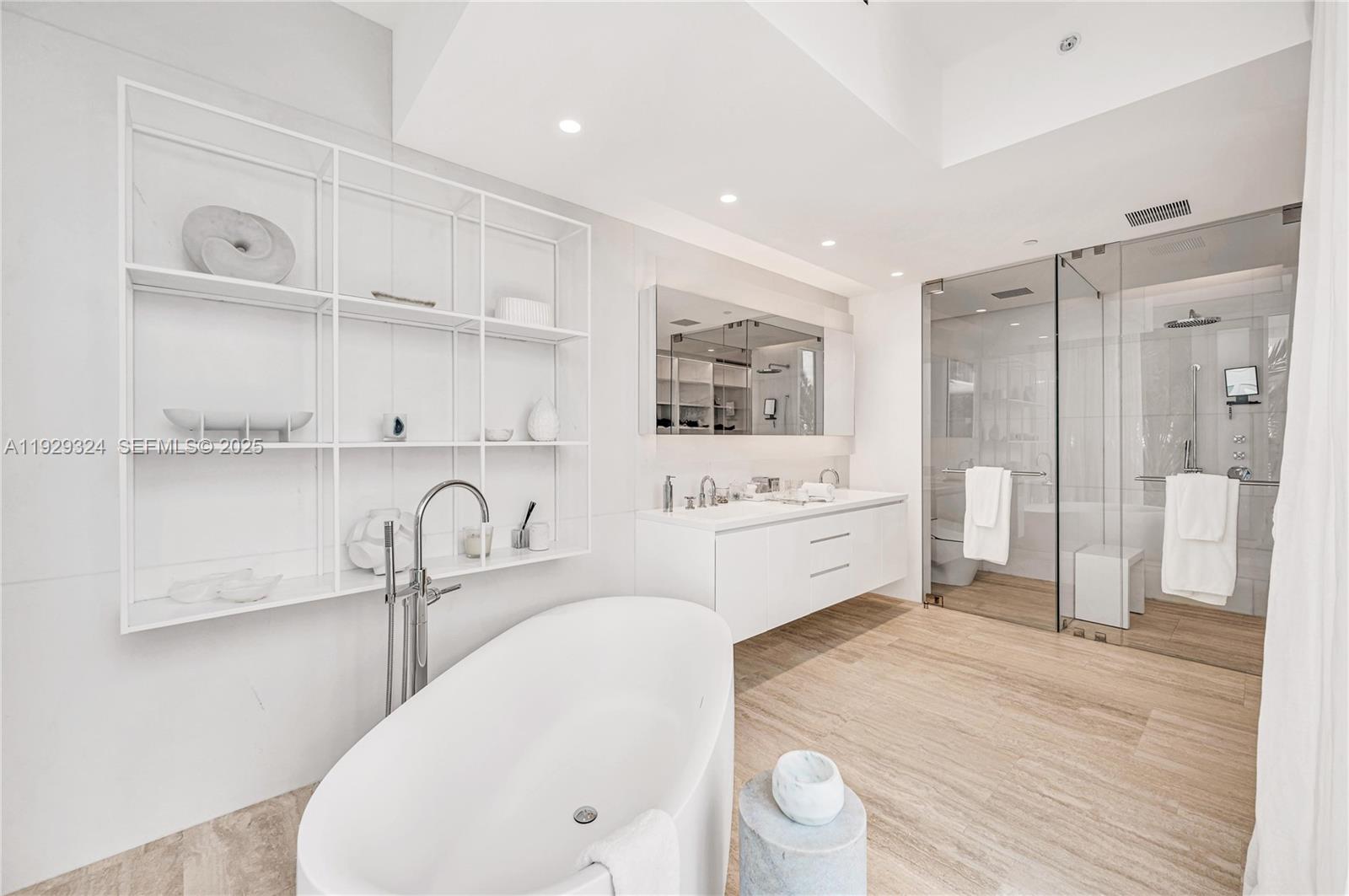 9111 Collins Avenue, Unit N322 Surfside, FL 33154 - Photo 11 of 23 a kitchen with a sink a refrigerator and cabinets