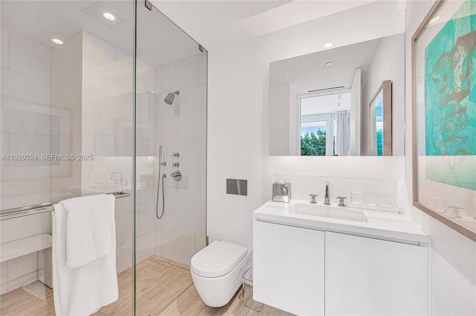 9111 Collins Avenue, Unit N322 Surfside, FL 33154 - Photo 15 of 23 a bathroom with a sink toilet and shower