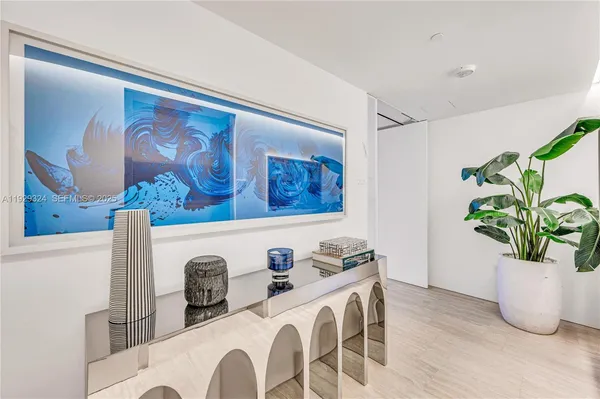 a dining room with furniture and potted plant
