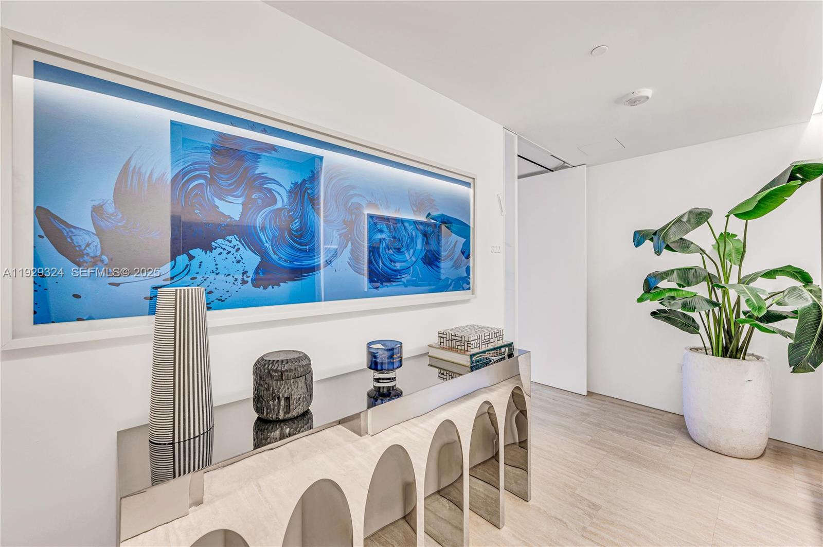 9111 Collins Avenue, Unit N322 Surfside, FL 33154 - Photo 16 of 23 a dining room with furniture and potted plant