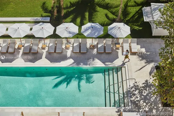 a view of swimming pool with outdoor seating and plants