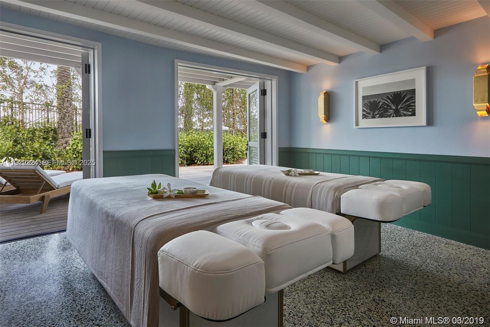 9111 Collins Avenue, Unit N322 Surfside, FL 33154 - Photo 21 of 23 a bedroom with a bed and a large window