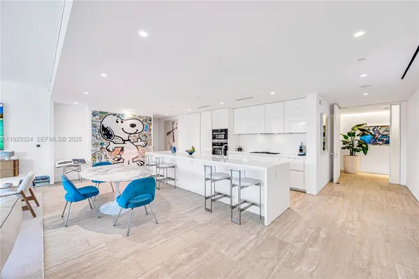 a living room with furniture and kitchen view